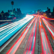 Cars and trucks are slowly moving during the evening's rush hour on the 101 in Los Angeles.